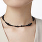 Black beaded necklace on a mannequin with a plain background