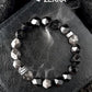 Bracelet with geometric beads on a textured surface, featuring the brand 'Zerra'.