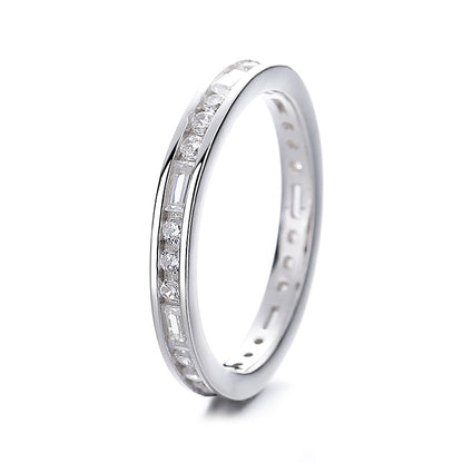 Silver ring with embedded diamonds on a white background