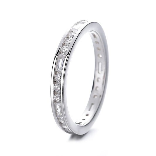 Silver ring with embedded diamonds on a white background