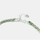 Green beaded bracelet on a white background