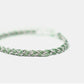 Green braided bracelet on a white background