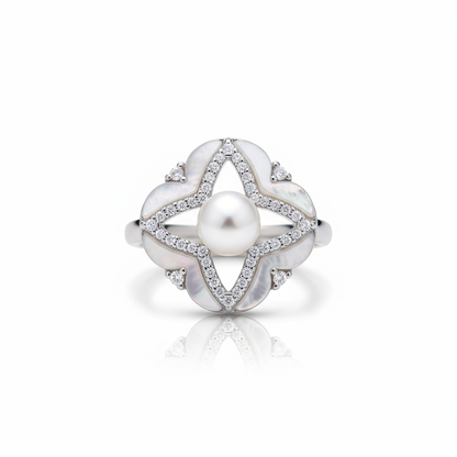 Silver ring with a pearl and diamond accents on a white background