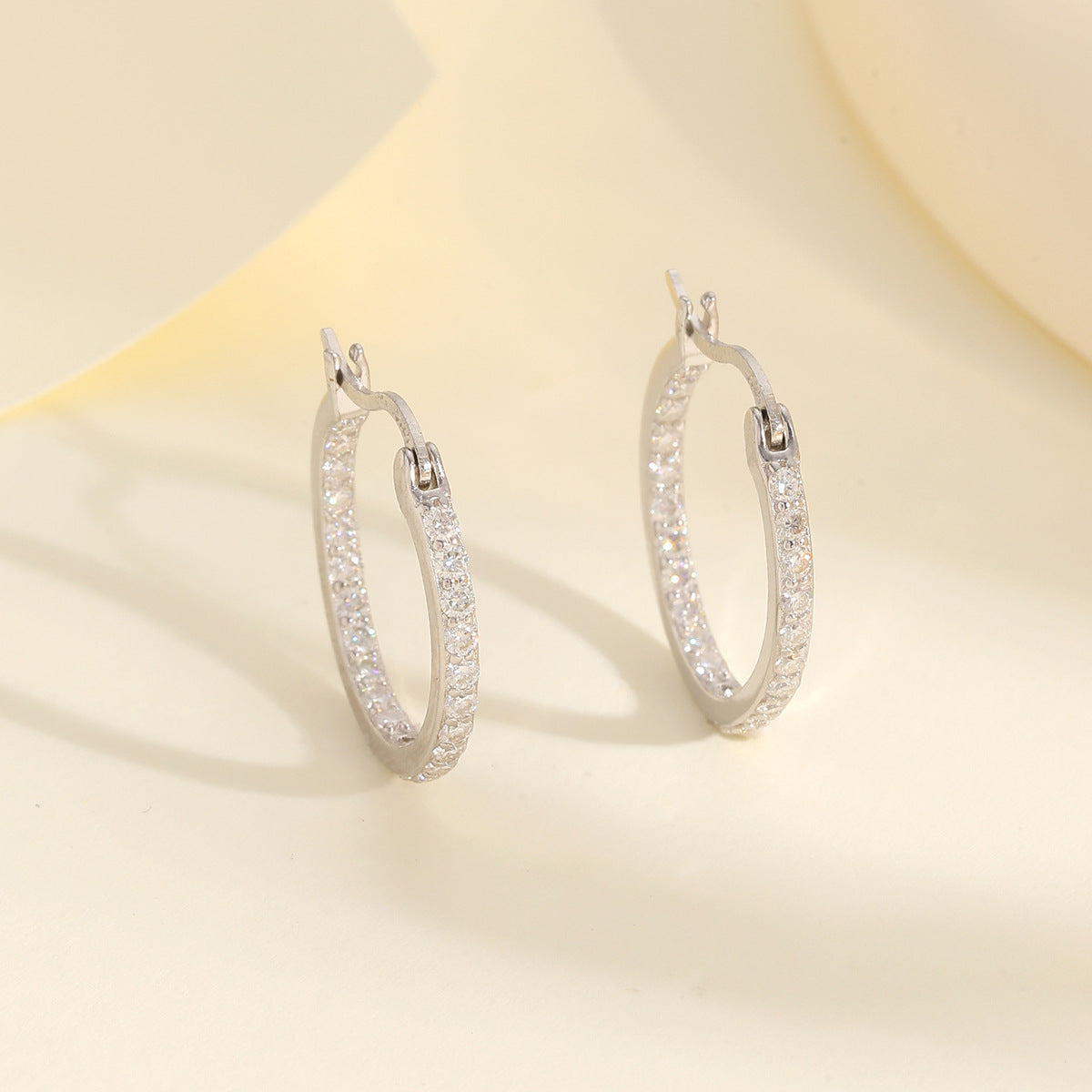 Yellow gold 1.4mm moissanite hoops on neutral background. Alt: “1.4mm Moissanite Hoop Earrings – 18K Yellow Gold.”