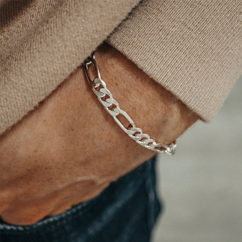 "Male model wearing minimalist Figaro silver bracelet with casual streetwear"