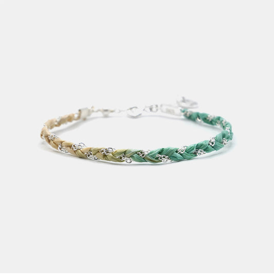 This Gradient Woven Bracelet features a unique blend of pink and green hues, handwoven with precision and paired with a delicate 925 sterling silver chain.
