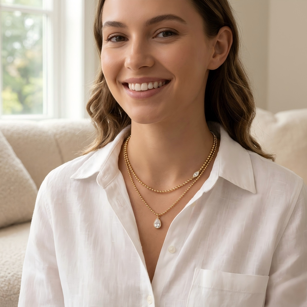 Female model wearing both necklaces layered together on bare skin or with an outfit.