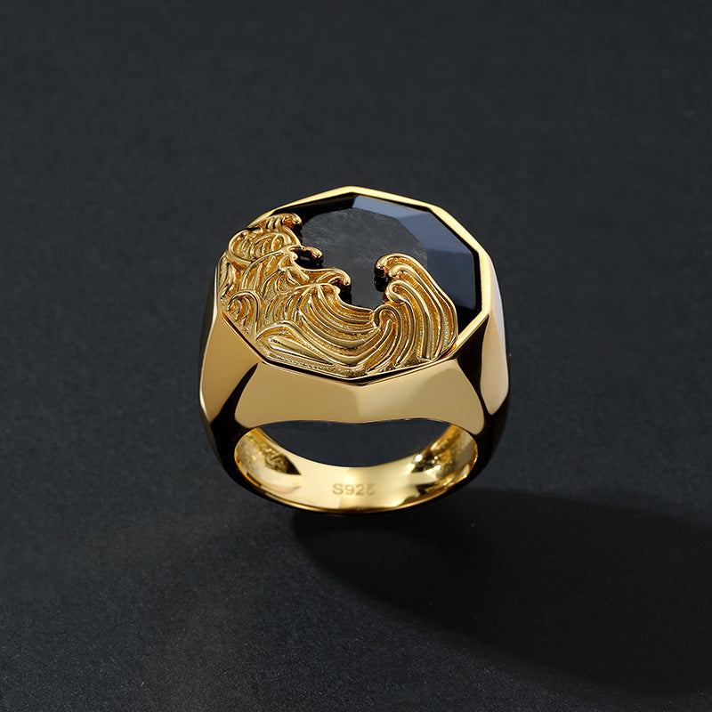 Gold ring with eagle emblem on a black background