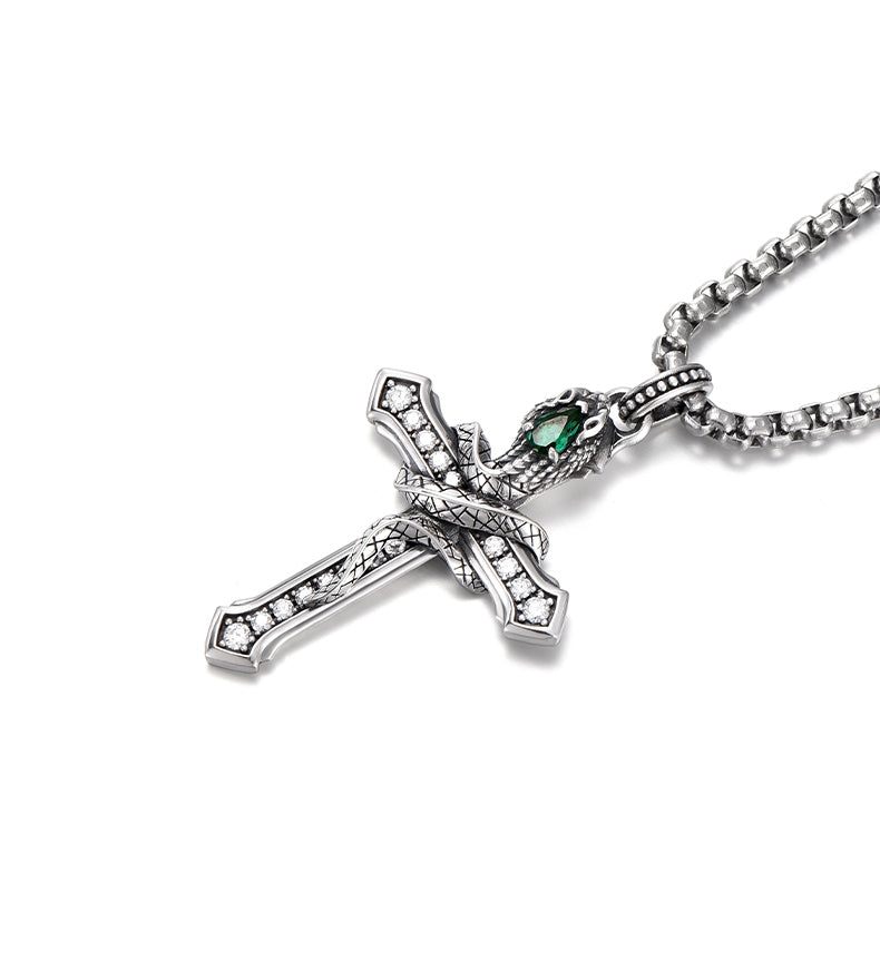 “Close-up of sterling silver serpent cross pendant with detailed craftsmanship”