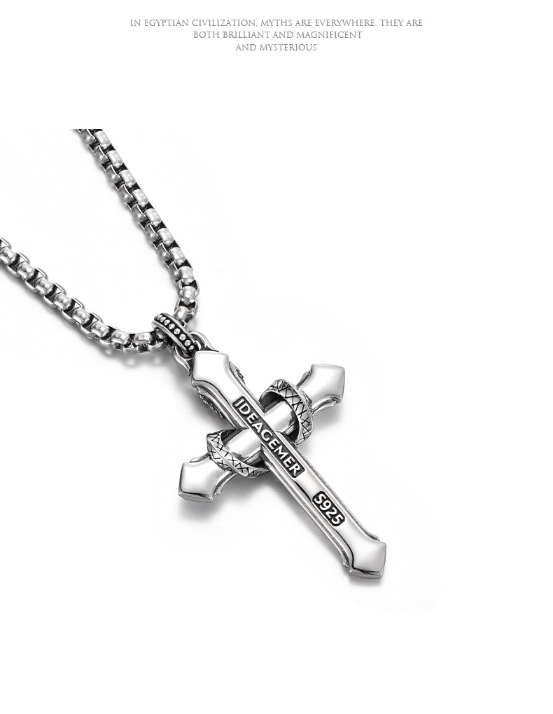 “Close-up of sterling silver serpent cross pendant with detailed craftsmanship”