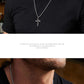 “Male model wearing serpent cross necklace in gothic masculine style”