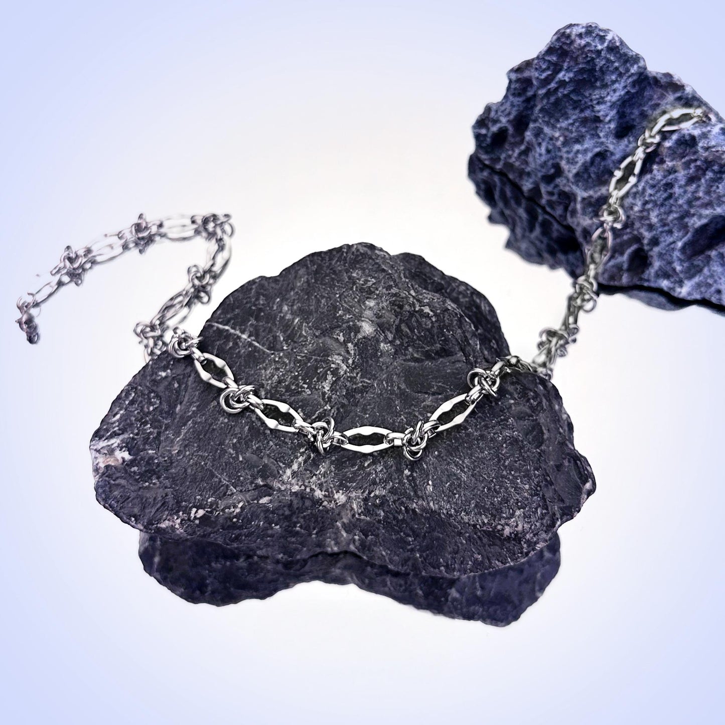 Streetwear-style silver necklace detail close-up