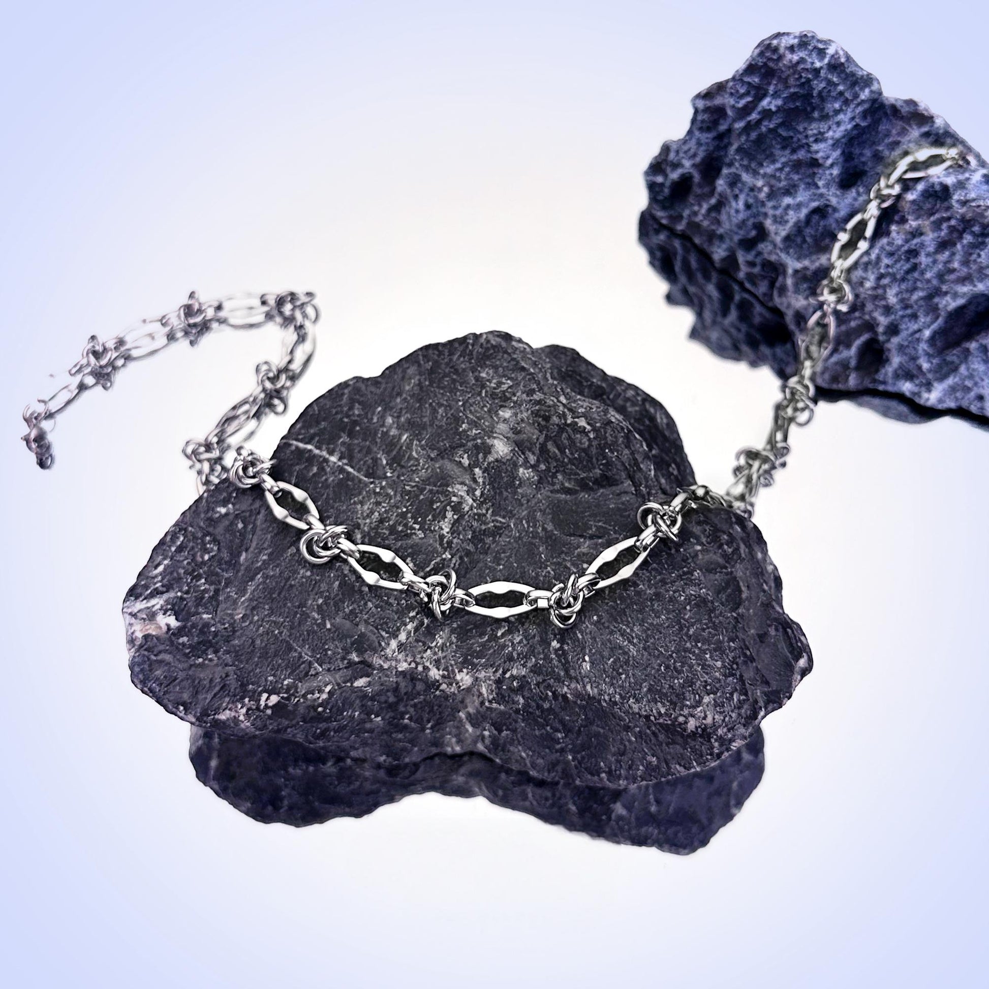 Streetwear-style silver necklace detail close-up