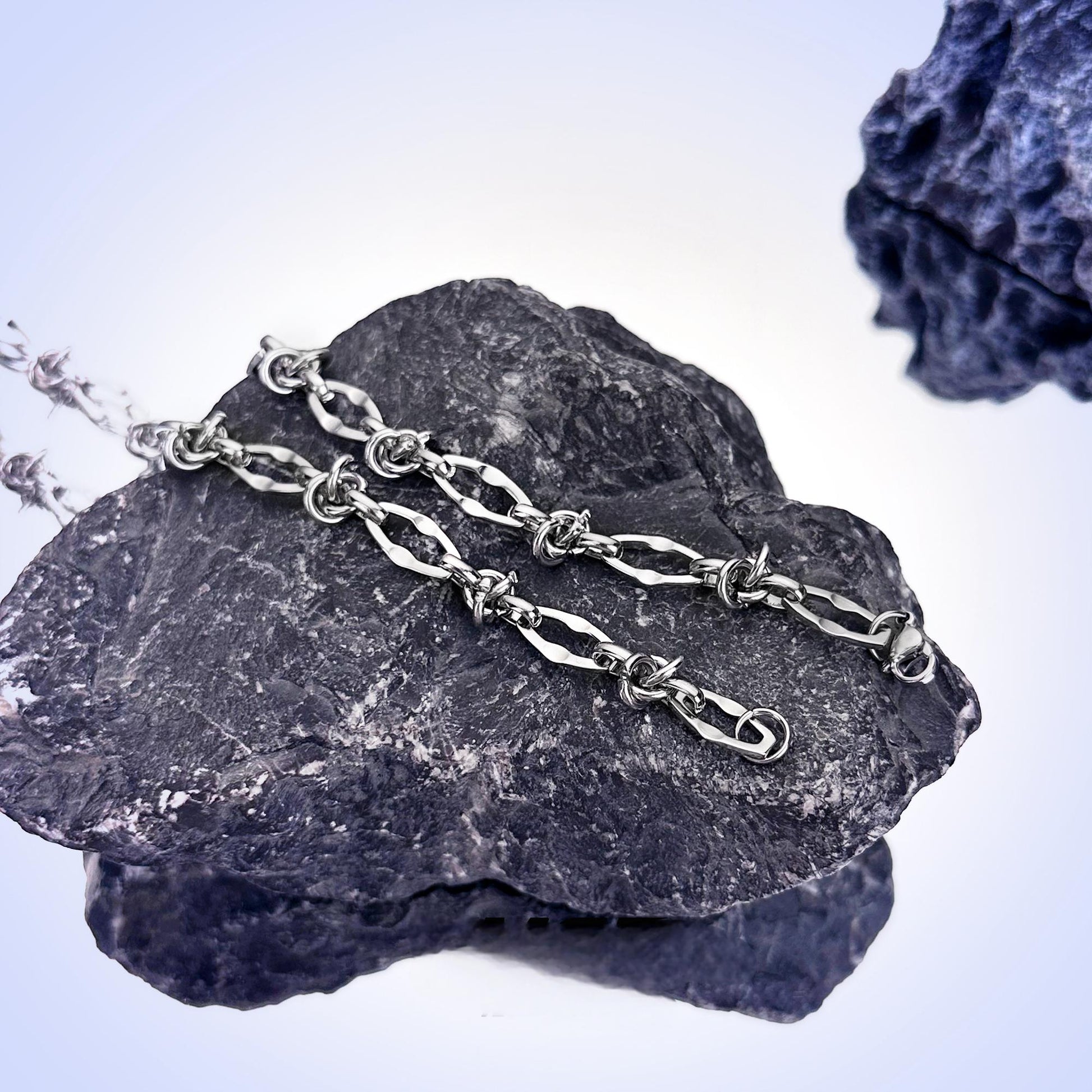 Streetwear-style silver necklace detail close-up