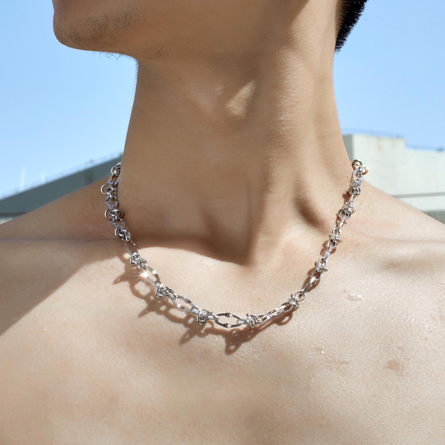 Male model wearing thorn knot Cuban silver chain