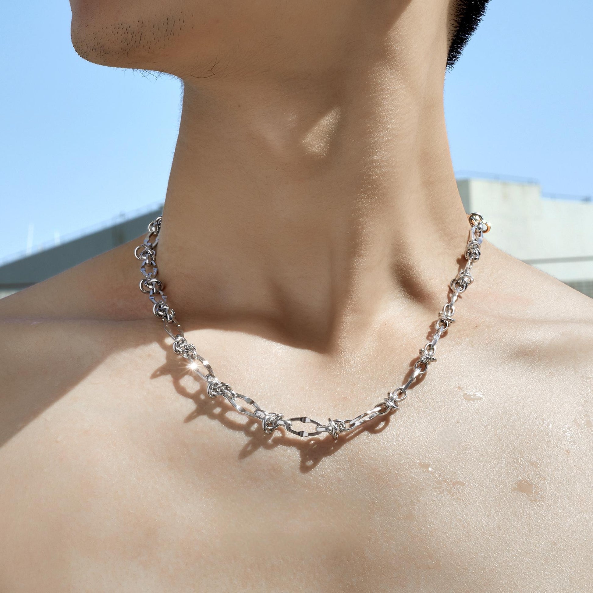 Male model wearing thorn knot Cuban silver chain
