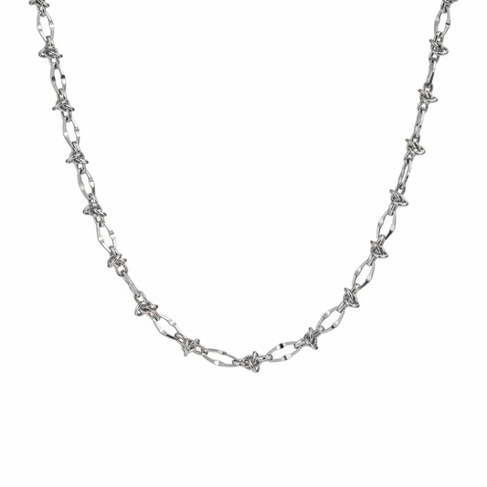 Male model wearing thorn knot Cuban silver chain