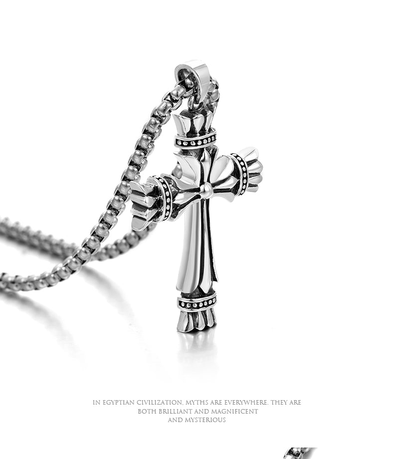 “Close-up of vintage sterling silver cross pendant with oxidized details”