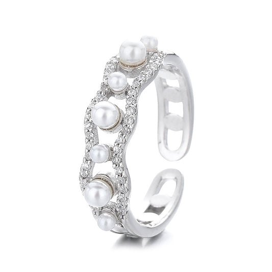 Silver ring with pearls on a white background