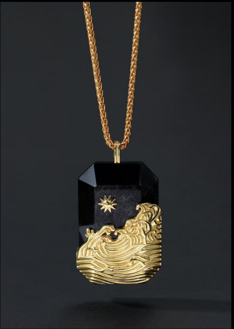 Gold and black pendant necklace on a dark background