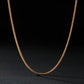 Gold chain necklace on a black background