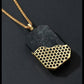 Necklace with a black pendant featuring a gold honeycomb pattern on a dark background