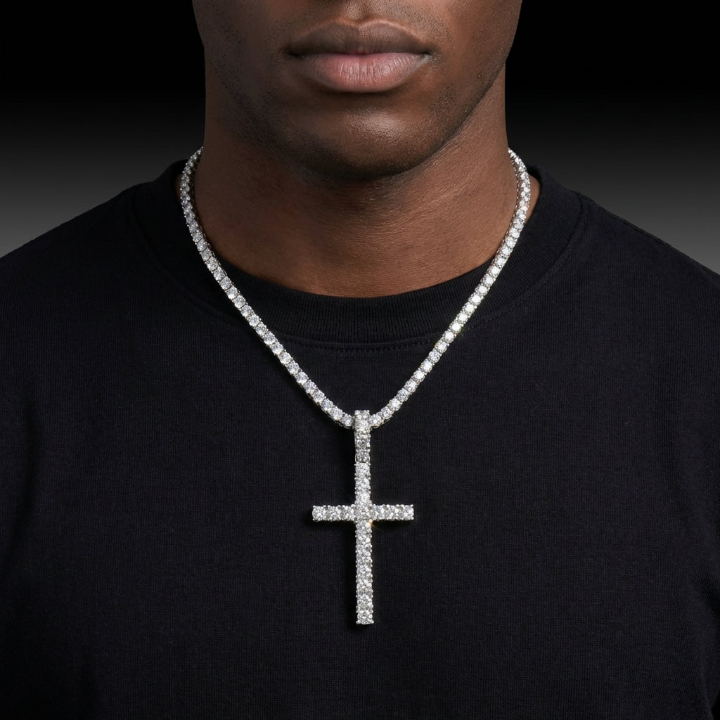 Man wearing a black shirt with a diamond-studded cross necklace against a dark background