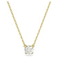 Gold necklace with a round diamond pendant on a white background