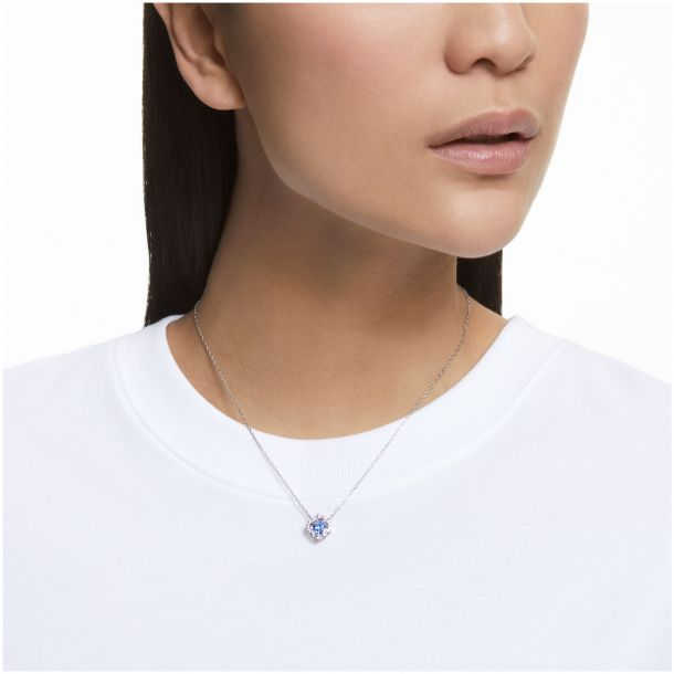 Swarovski Crystal Blue Dancing Clover NecklaceNecklace with a blue pendant worn by a person on a white background