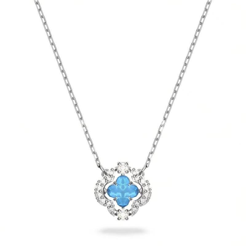 Swarovski Crystal Blue Dancing Clover NecklaceNecklace with a blue clover-shaped pendant on a white background