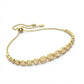 Gold bracelet with round embellishments on a white background