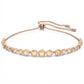 Rose gold bracelet with clear gemstones on a white background