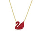 Red swan pendant necklace on a gold chain against a white background