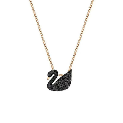 Black swan pendant necklace on a rose gold chain against a white background