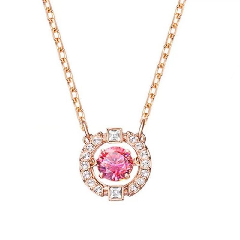 Swarovski Sparkling Dance Round Red Crystal Pendant in Rose GoldNecklace with a pink gemstone and rose gold chain on a white background