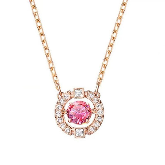 Swarovski Sparkling Dance Round Red Crystal Pendant in Rose GoldNecklace with a pink gemstone and rose gold chain on a white background