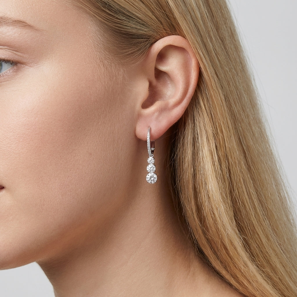 Close-up of a woman wearing a silver hoop earring with a blurred background