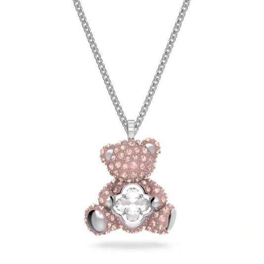 Swarovski Teddy pendant Bear, Pink, Rhodium platedPink teddy bear pendant with a white gemstone on a silver chain against a white background