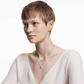 Swarovski Women's Una Crystal Jewelry Collection, Rose Gold Tone FinishWoman wearing a necklace with a plain background