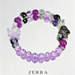 Purple beaded bracelet with 'ENCHANTED' on a white background, featuring the brand 'ZERRA'.