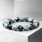 Bracelet with green and white beads on a gray background, featuring the brand 'Zerra'.