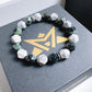 Bracelet with green and white stones on a branded box