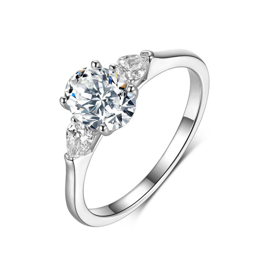 Romantic flat lay featuring 4–5 three stone rings on soft, timeless background. Alt: “Three Stone Oval Moissanite Engagement Rings – Past, Present, Future Collection.”
