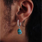 “Unisex turquoise earrings worn as ethnic boho fashion accessory”