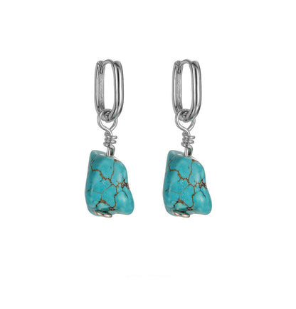 “Handmade Tibetan-style S925 silver earrings with raw turquoise – flat lay”