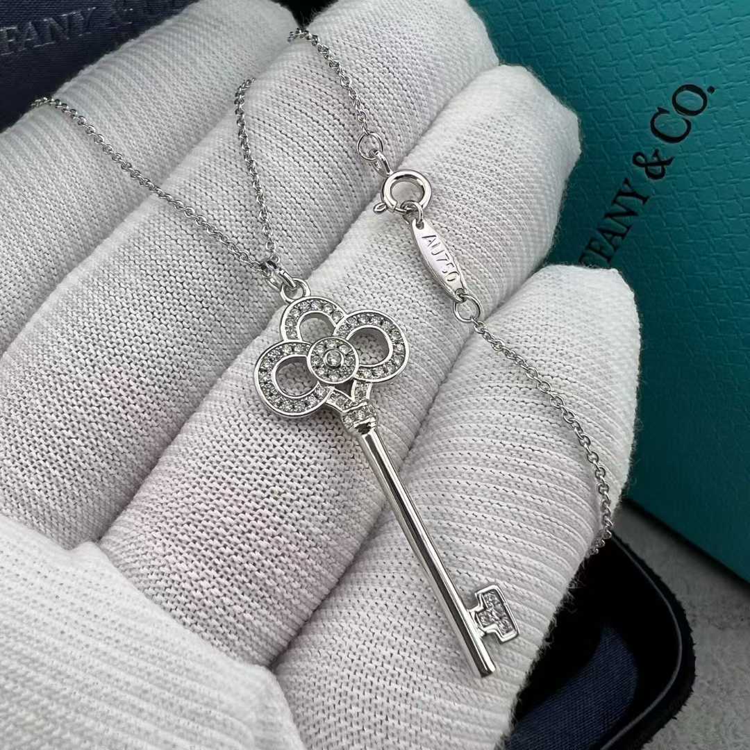 “Tiffany & Co. Keys Collection mini crown key pendant necklace flat lay”