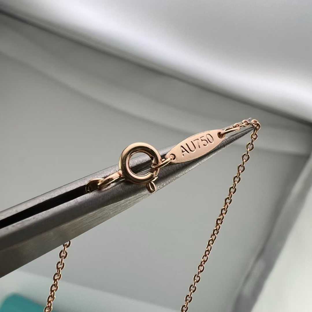 “Close-up of pavé set cubic zirconia on Tiffany crown key pendant”