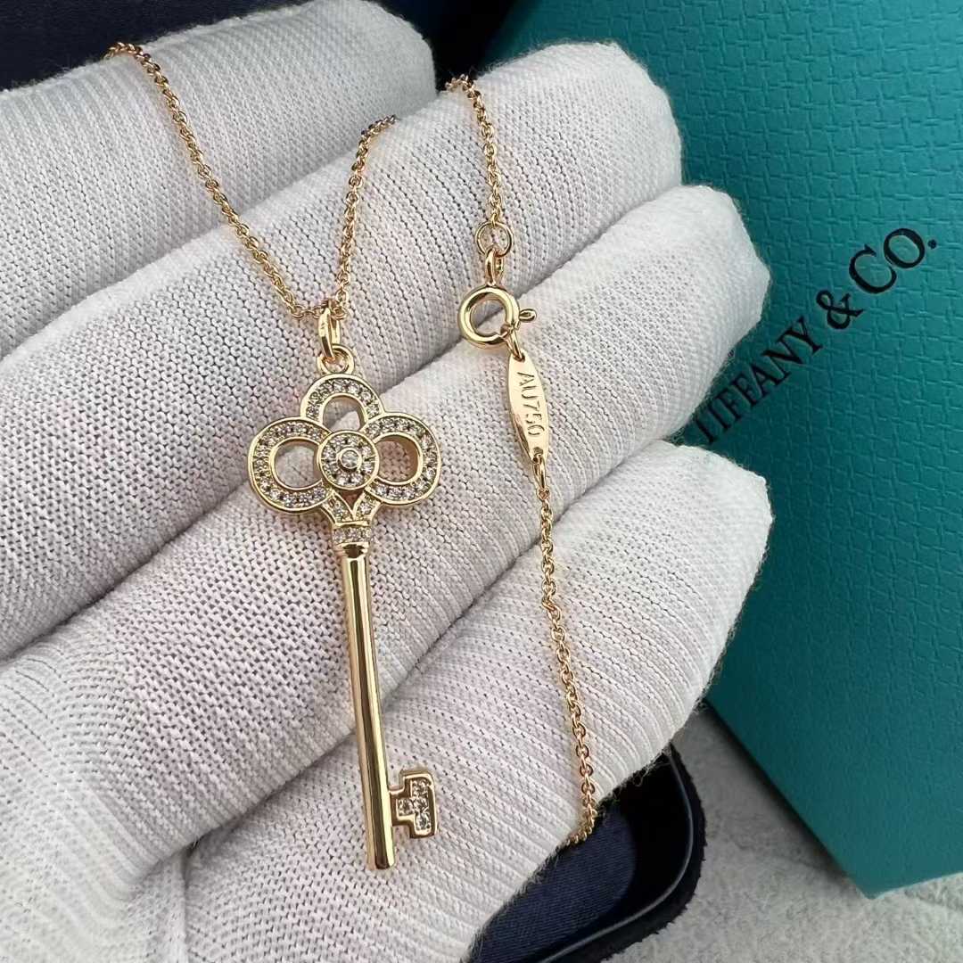 “Tiffany & Co. Keys Collection mini crown key pendant necklace flat lay”