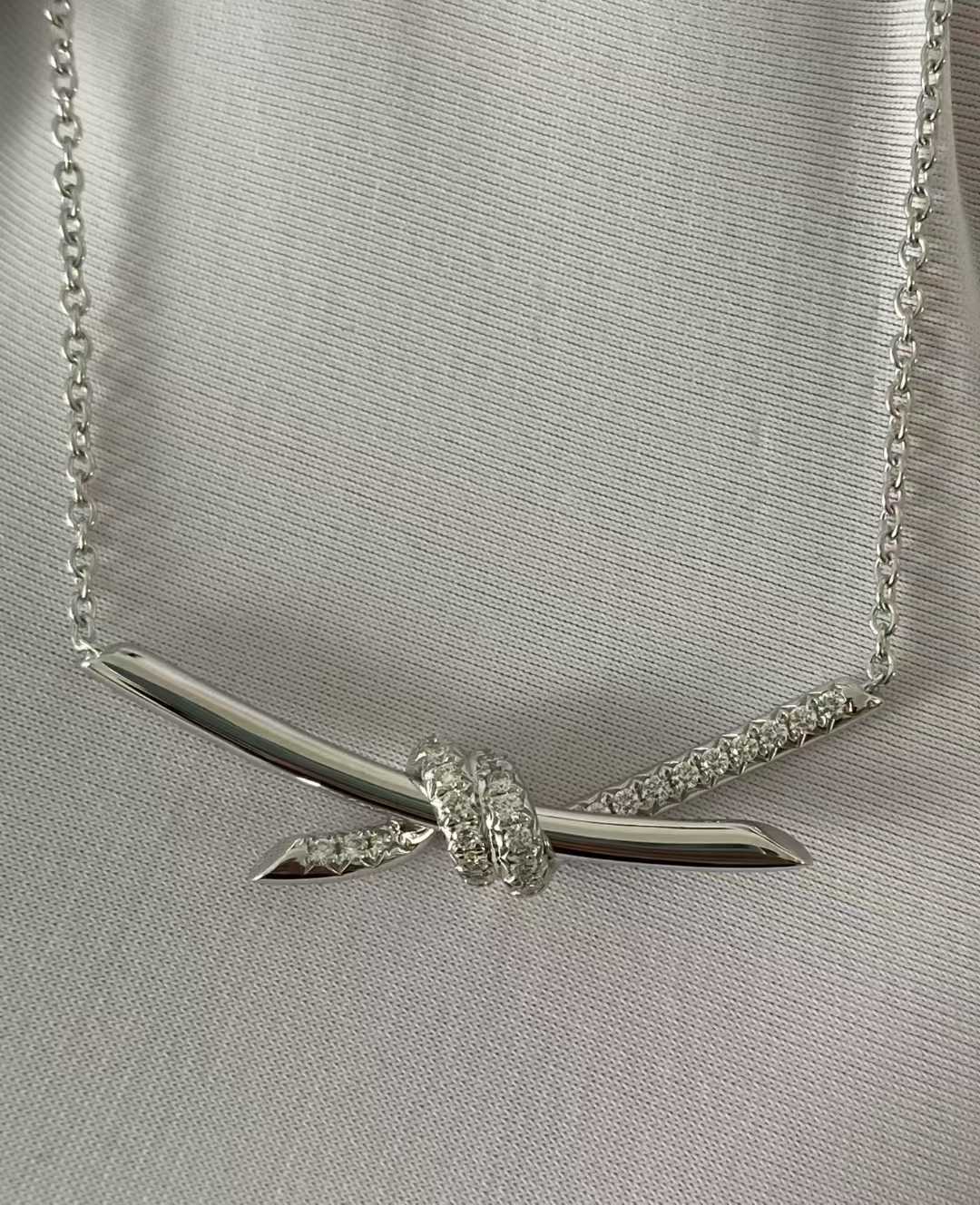 “Close-up of Tiffany Knot pendant design in 18K gold”