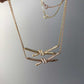 “Tiffany Knot pendant necklace in 18K gold flat lay”